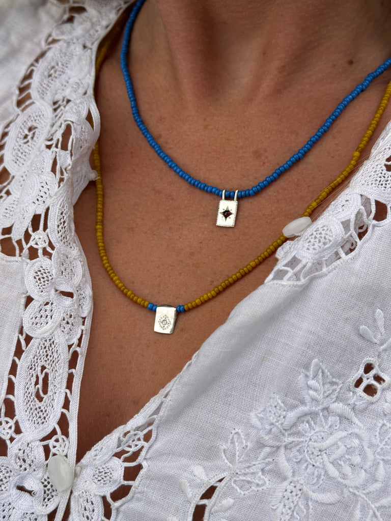 Antique bead necklace with silver and garnet pendant