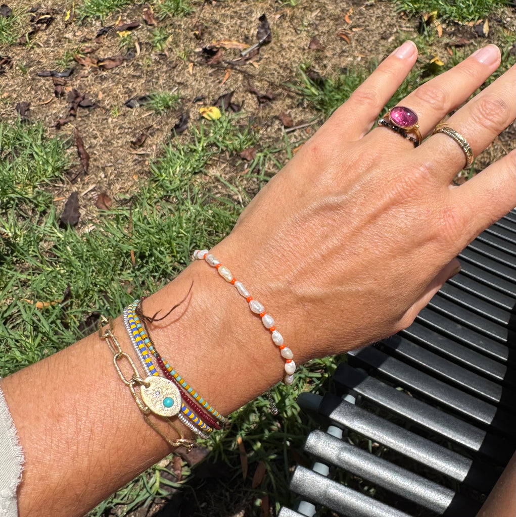 PEARL with orange bracelet